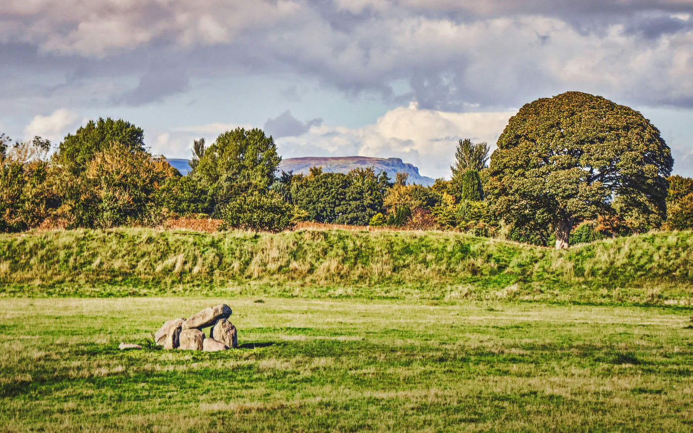 A stone monument in a green landscape; illustrative scenery, not a site identified with Niall.