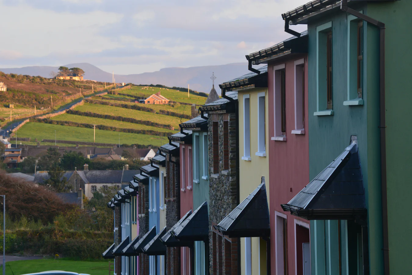 Houses beside open countryside; an illustrative scene for family origins and migration.