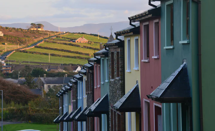Colourful houses with fields beyond, illustrating the relationship between settlement and countryside.
