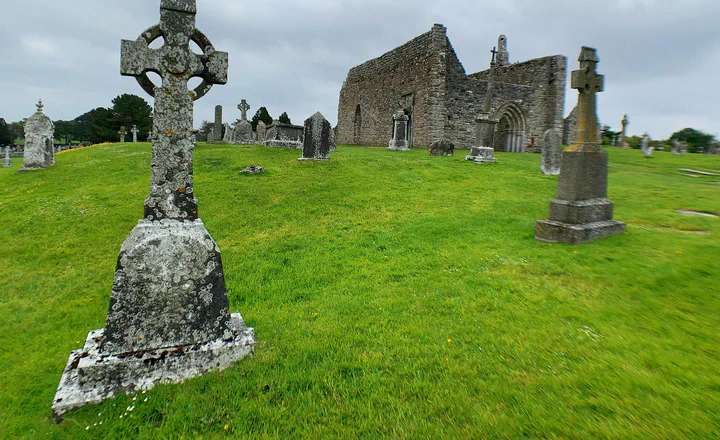 Church ruins and stone crosses beneath a cloudy sky; an illustrative historical landscape.